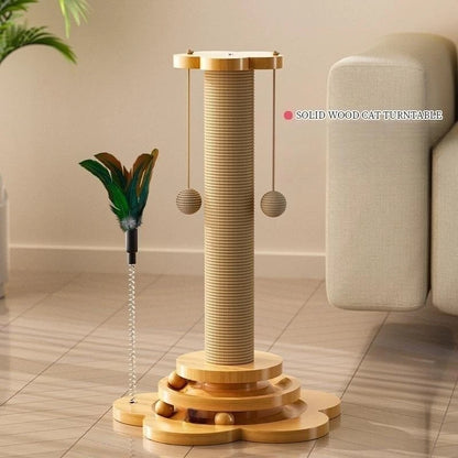 Wooden cat turntable with feather toy and balls on a tiled floor.